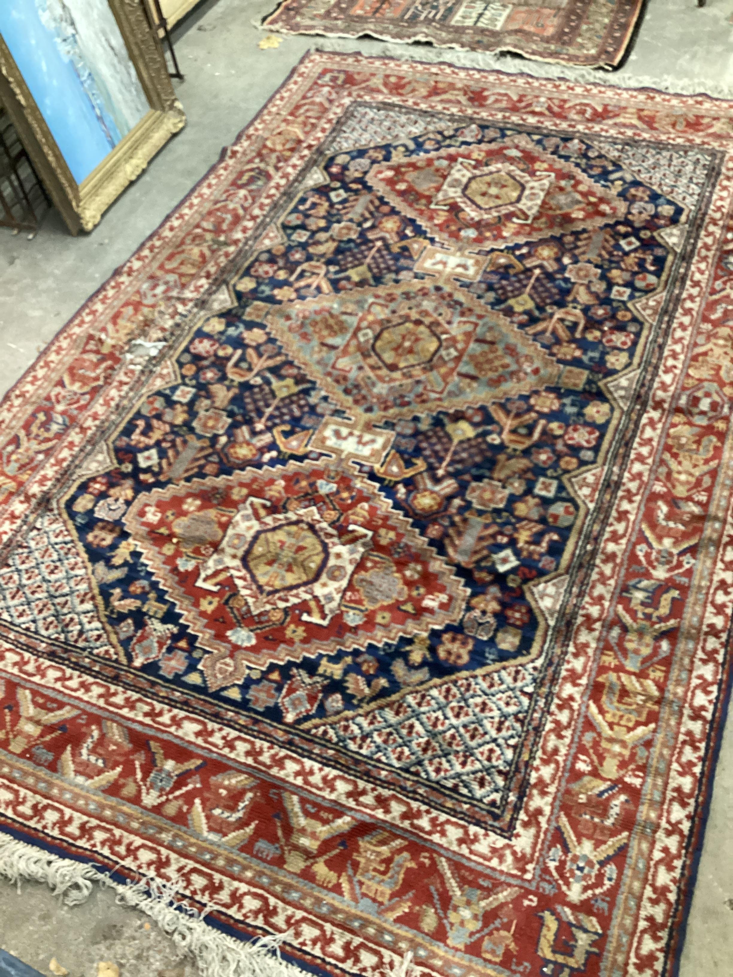 A Caucasian blue ground carpet (holed), 300 x 198cm